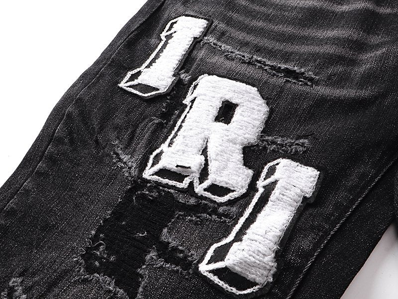 AMIRI Varsity Letter Appliqué Distressed Jeans